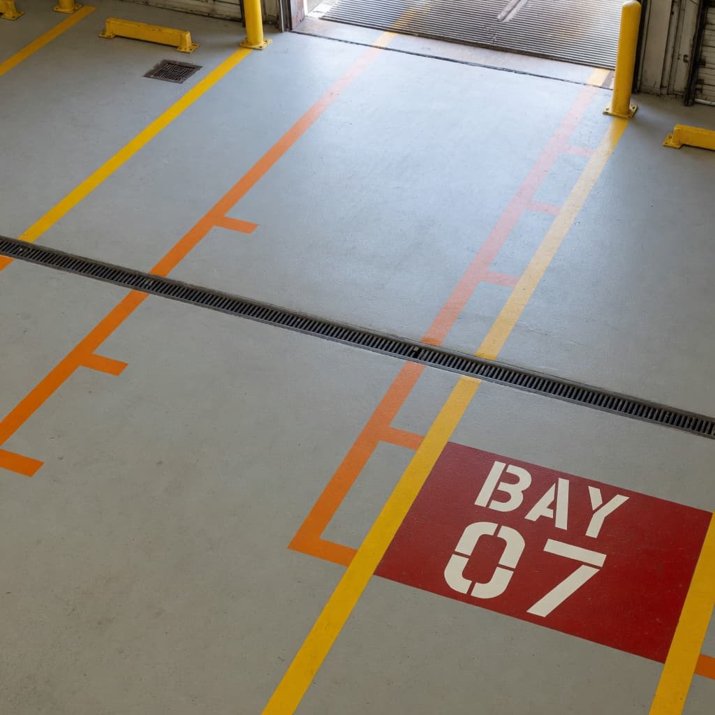 Logistics staging or transportation hub environment suited for fleet and dock-floor cleaning